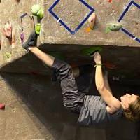 competitor climbing through cave